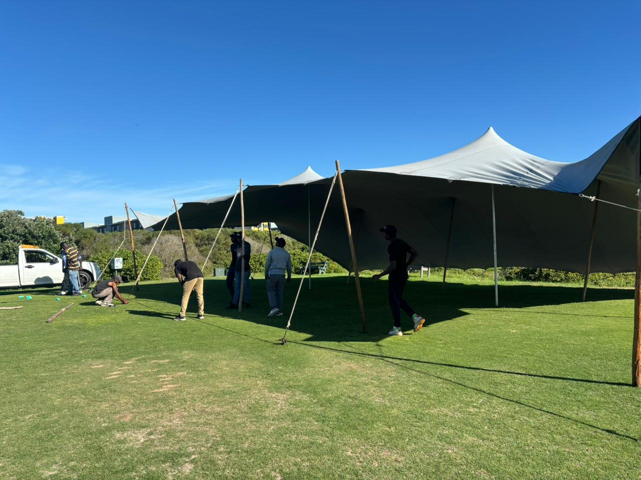 Crew installing large stretch tent